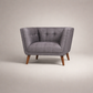 Gray armchair with wooden legs on a beige background