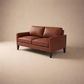 Cyrene W contemporary faux leather two seater sofa with wooden legs in warm tan upholstery isometric view