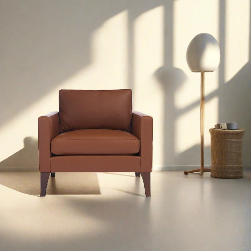 Cyrene W contemporary faux leather single seater sofa with wooden legs in warm tan upholstery front view