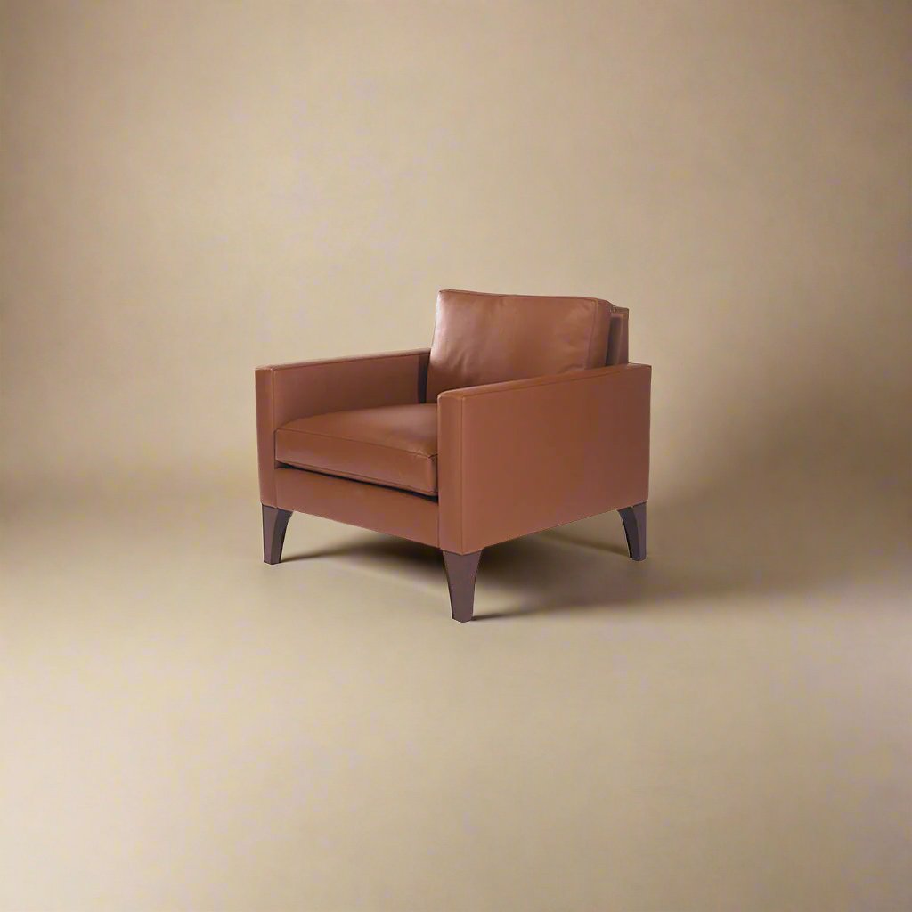 Cyrene W contemporary faux leather single seater sofa with wooden legs in warm tan upholstery isometric view