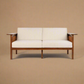Hibiki Japanese minimalist teakwood sofa with upholstered seat and back cushions and signature side leather panel detail – front view