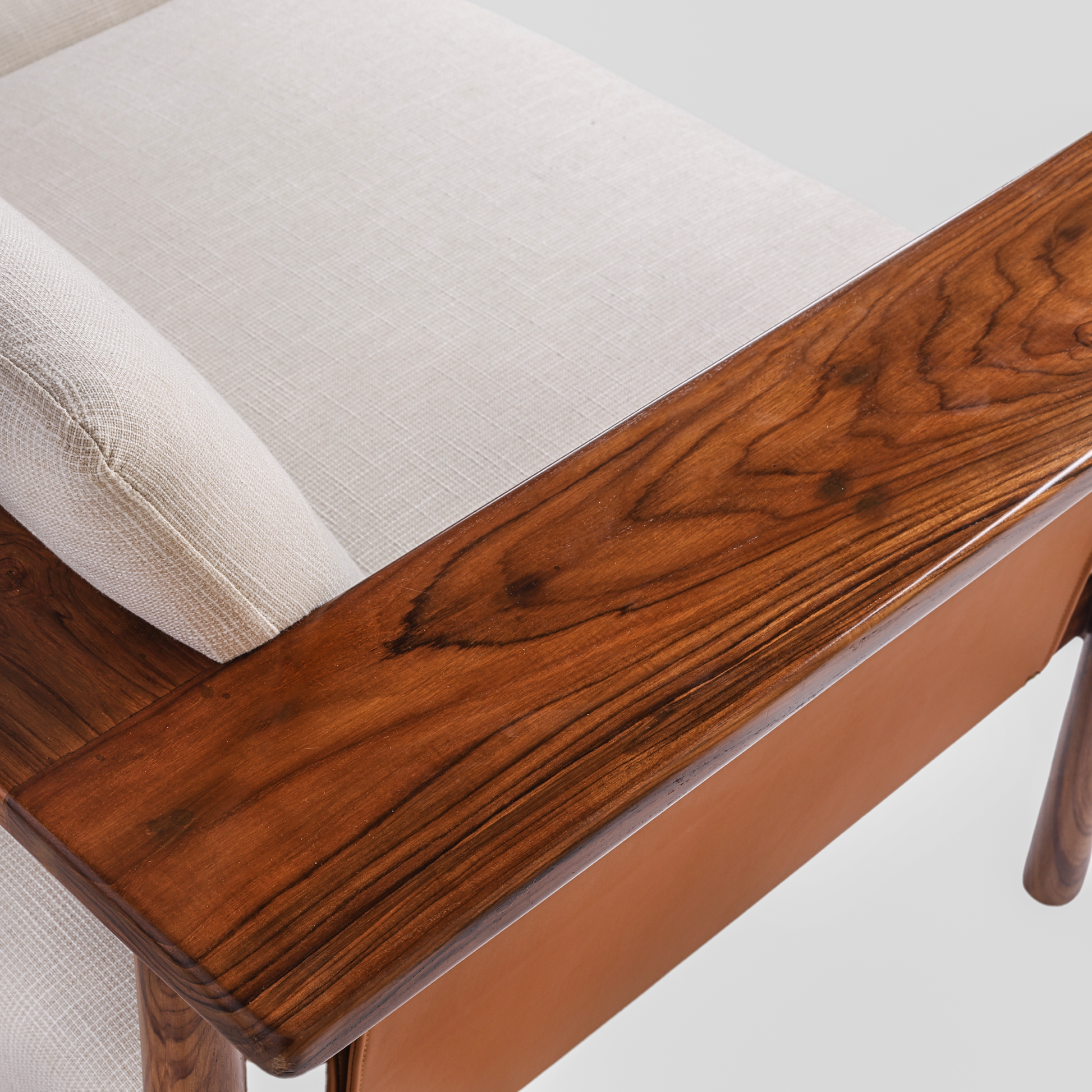 Hibiki Japanese minimalist teakwood sofa with upholstered seat and back cushions and signature side leather panel detail – teakwood grain detail