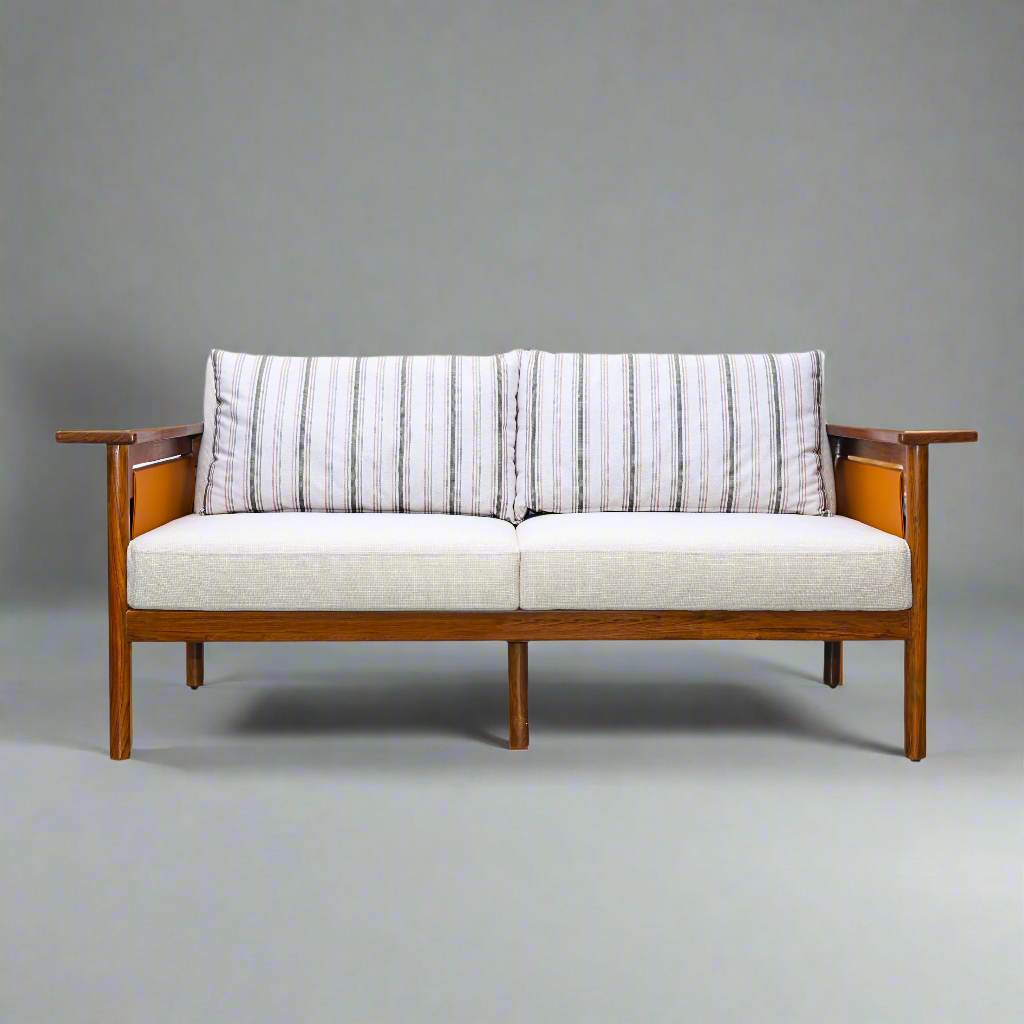 Hibiki Japanese minimalist teakwood sofa with upholstered seat and back cushions and signature side leather panel detail – front view with cushions