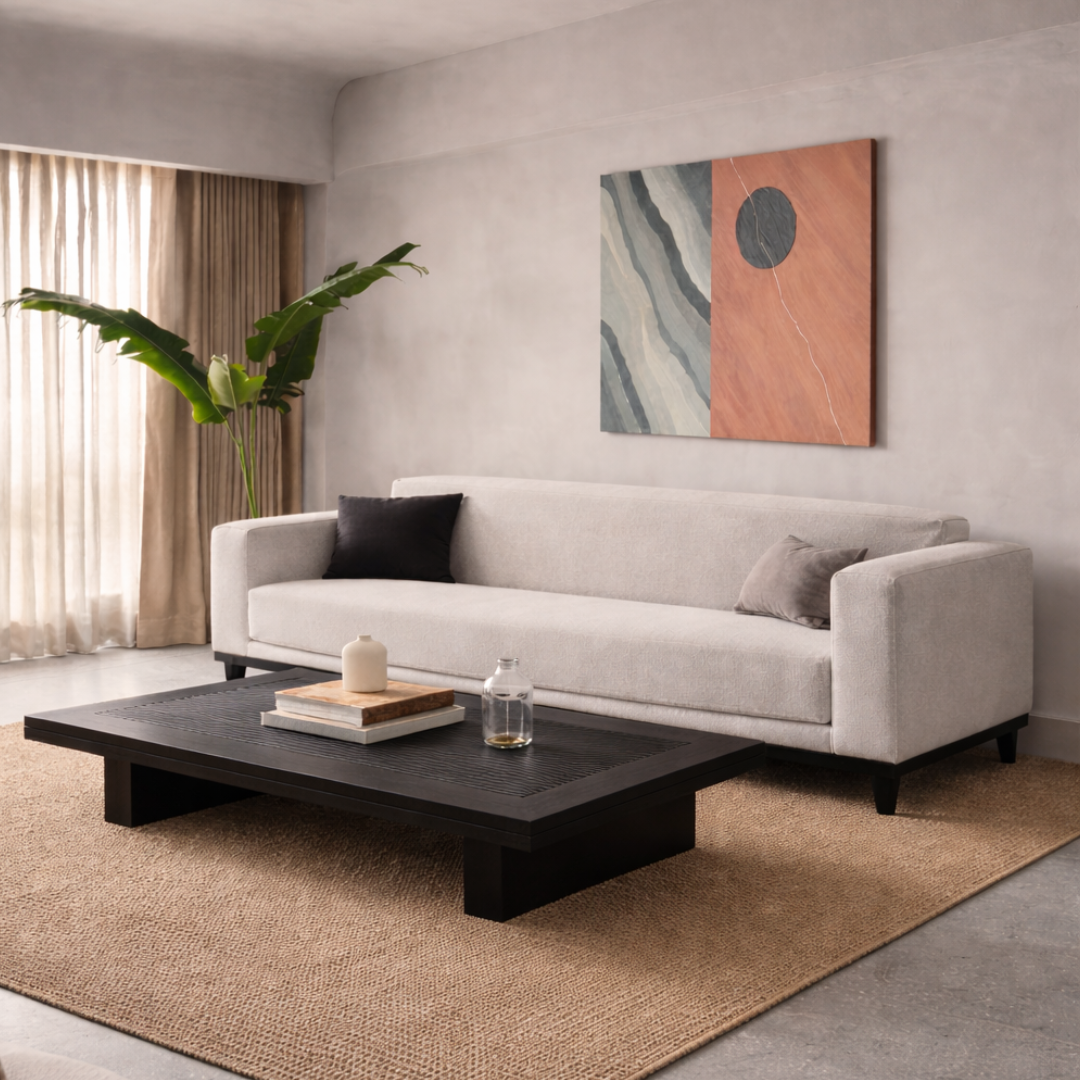 Irene modern fabric sofa in a contemporary living room setting with a wooden Noma coffee table, textured rug, and indoor plants, creating a calm and timeless seating space.