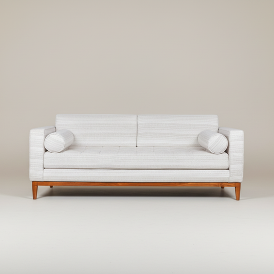 White sofa with wooden legs on a plain background