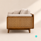 Trame mid-century modern sofa featuring a teakwood frame, woven rattan side panels, and cream fabric upholstery