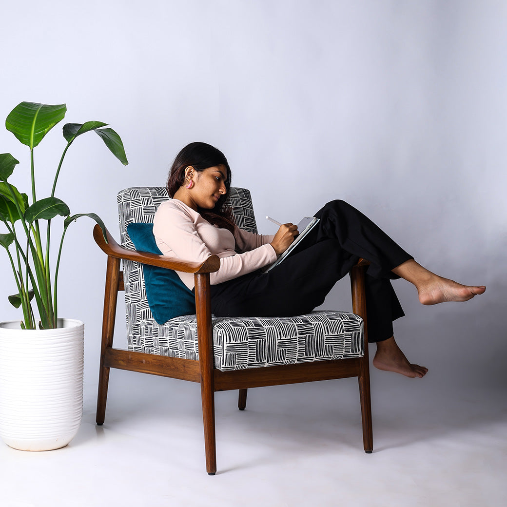 Juno wooden lounge chair handcrafted in teakwood by Bluedot Design – lifestyle view