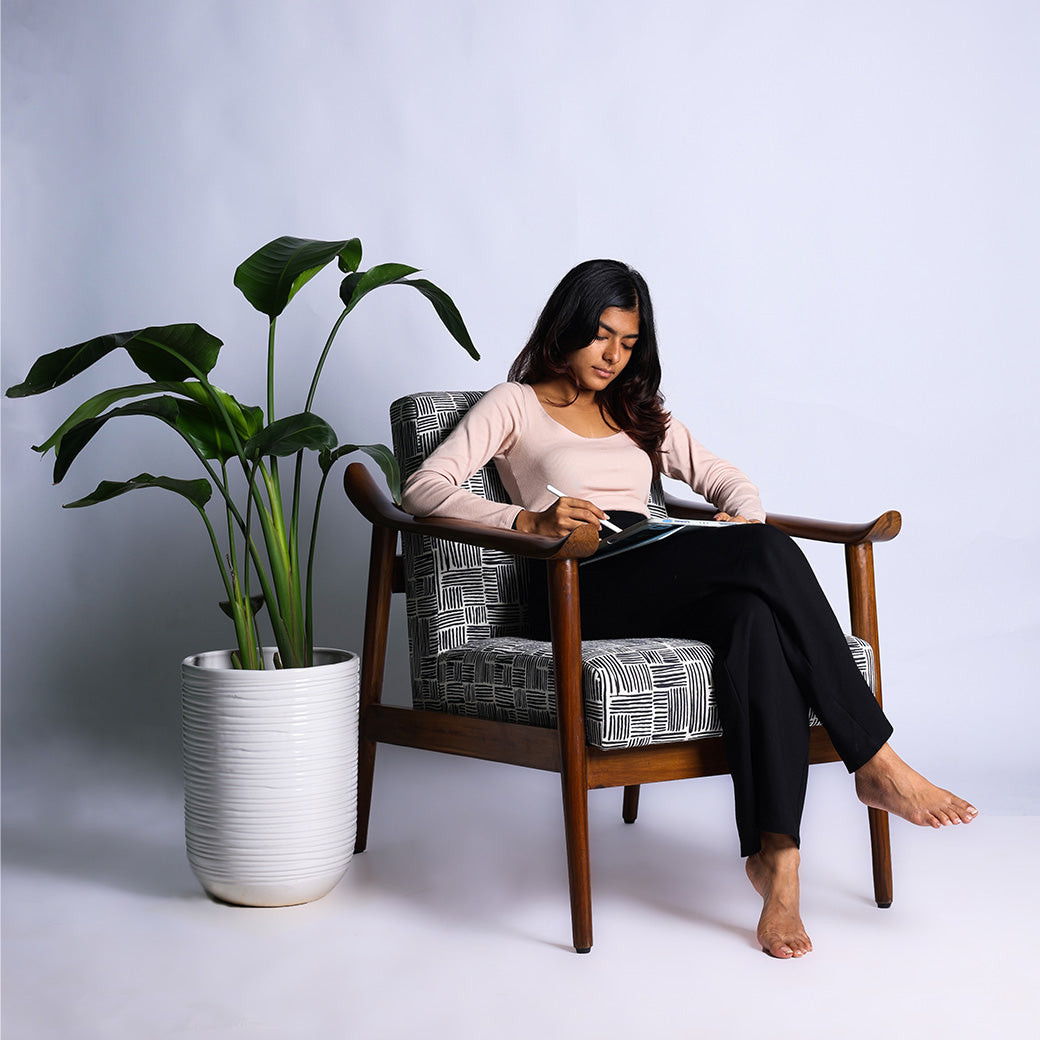 Juno wooden lounge chair handcrafted in teakwood by Bluedot Design – lifestyle view